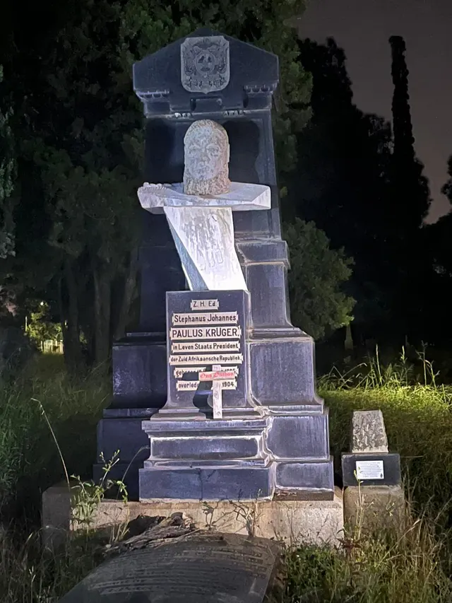 The inscribed Paulus Kruger memorial illuminated at night