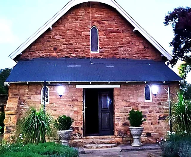 St George’s Church in Cullinan, with stone walls and an open front door in daylight