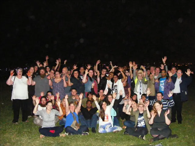 Tour guests posing together outdoors at night