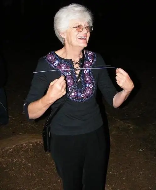 A guest holding demonstration rods during an evening event