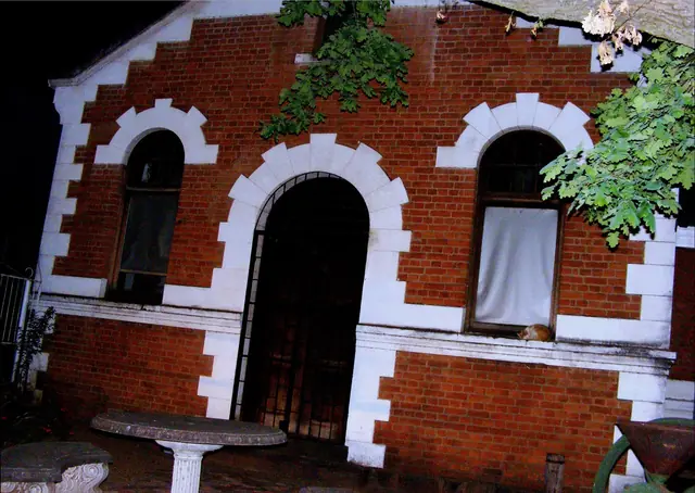 Red-brick museum façade with white arches