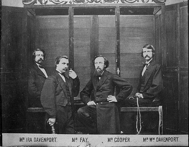 Black-and-white archival photograph of four Victorian-era performers