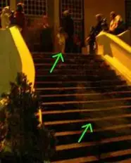 Archive photograph showing a tour host near a staircase